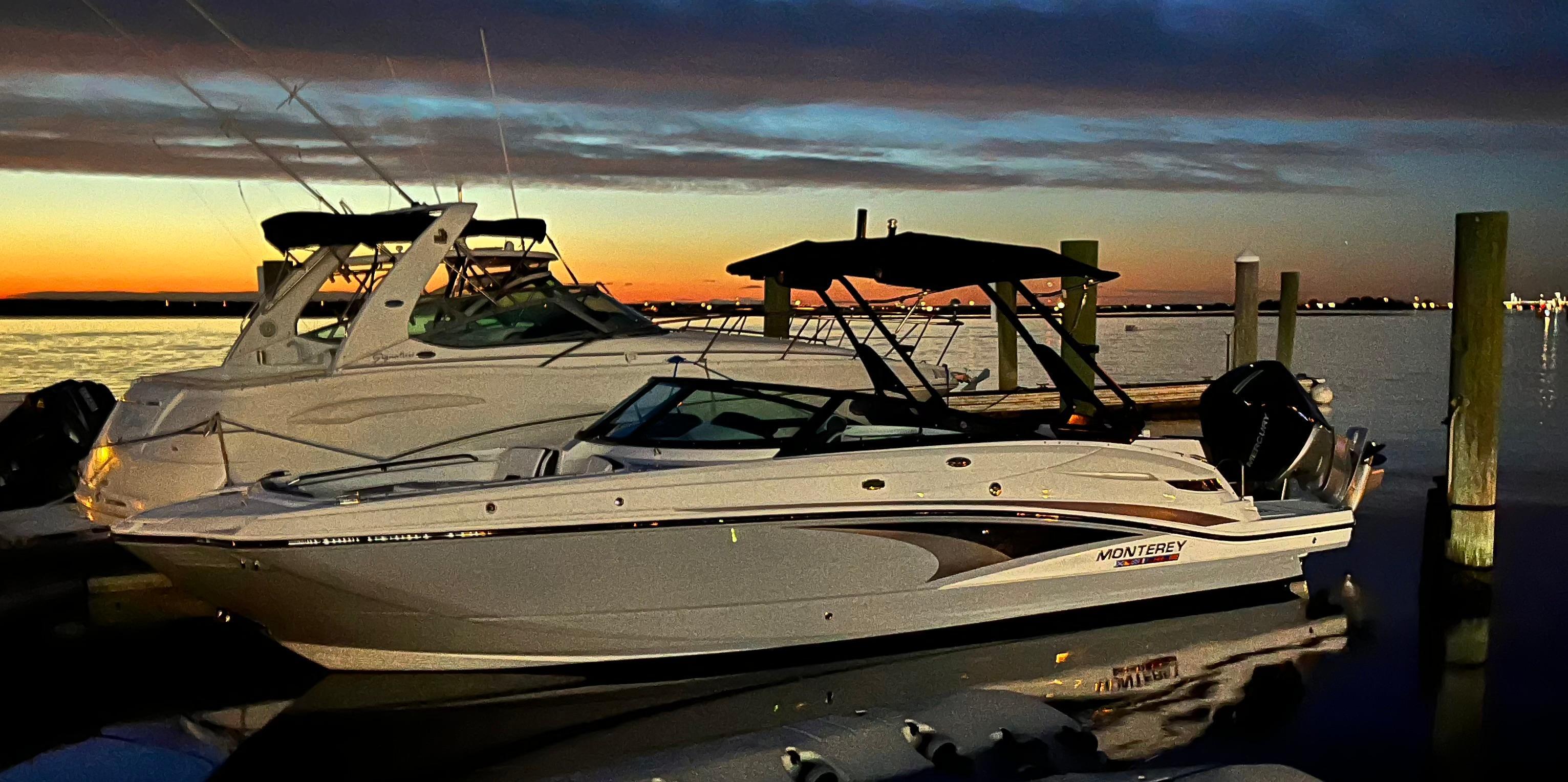Monterey M-65 2024 Monterey M-65 boat docked at sunset, reflecting on calm water.