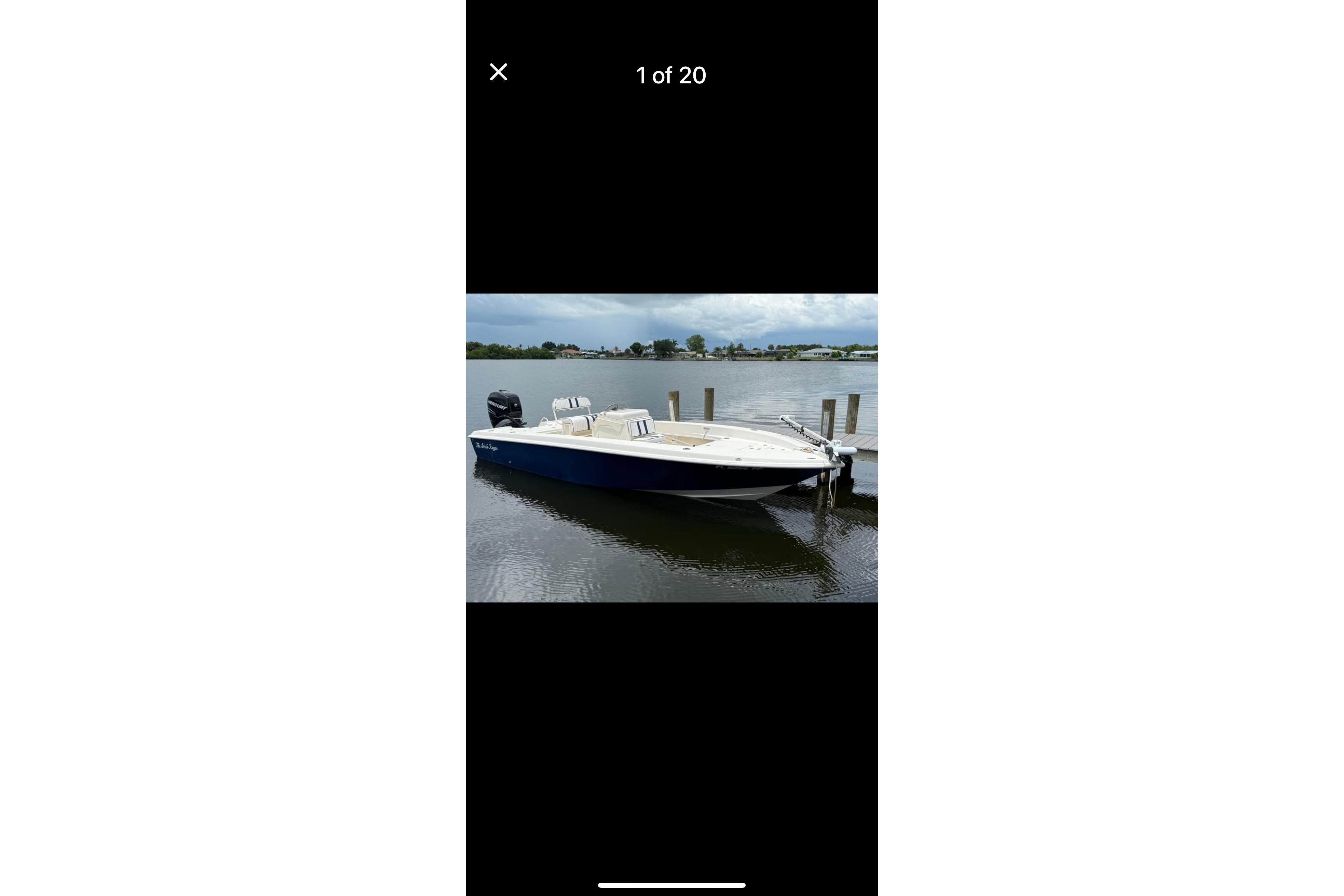 Young Boats 24 Center Console Bay Boat 2014 Young Boats 24 Center Console Bay Boat docked on calm water.