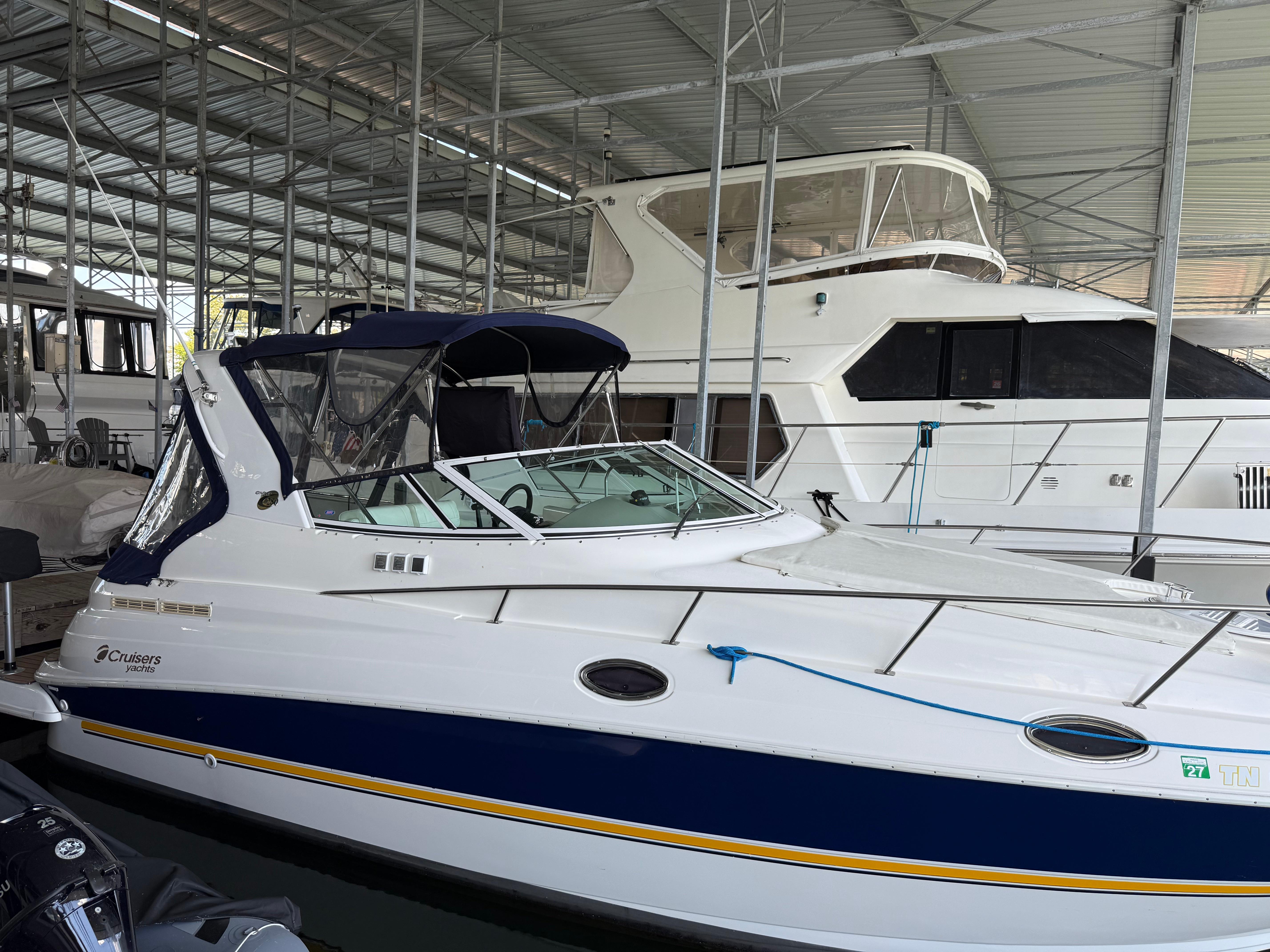 Cruisers Yachts 280 Express 2004 Cruisers Yachts 280 Express docked in a covered marina.