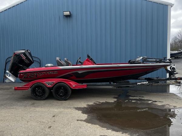 Nitro Z21 XL Pro 2023 Nitro Z21 XL Pro bass boat in red and black, parked on a trailer.