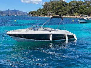 Regal 2000 Bowrider 2014 Regal 2000 Bowrider boat floating on clear blue water near a scenic coastline.