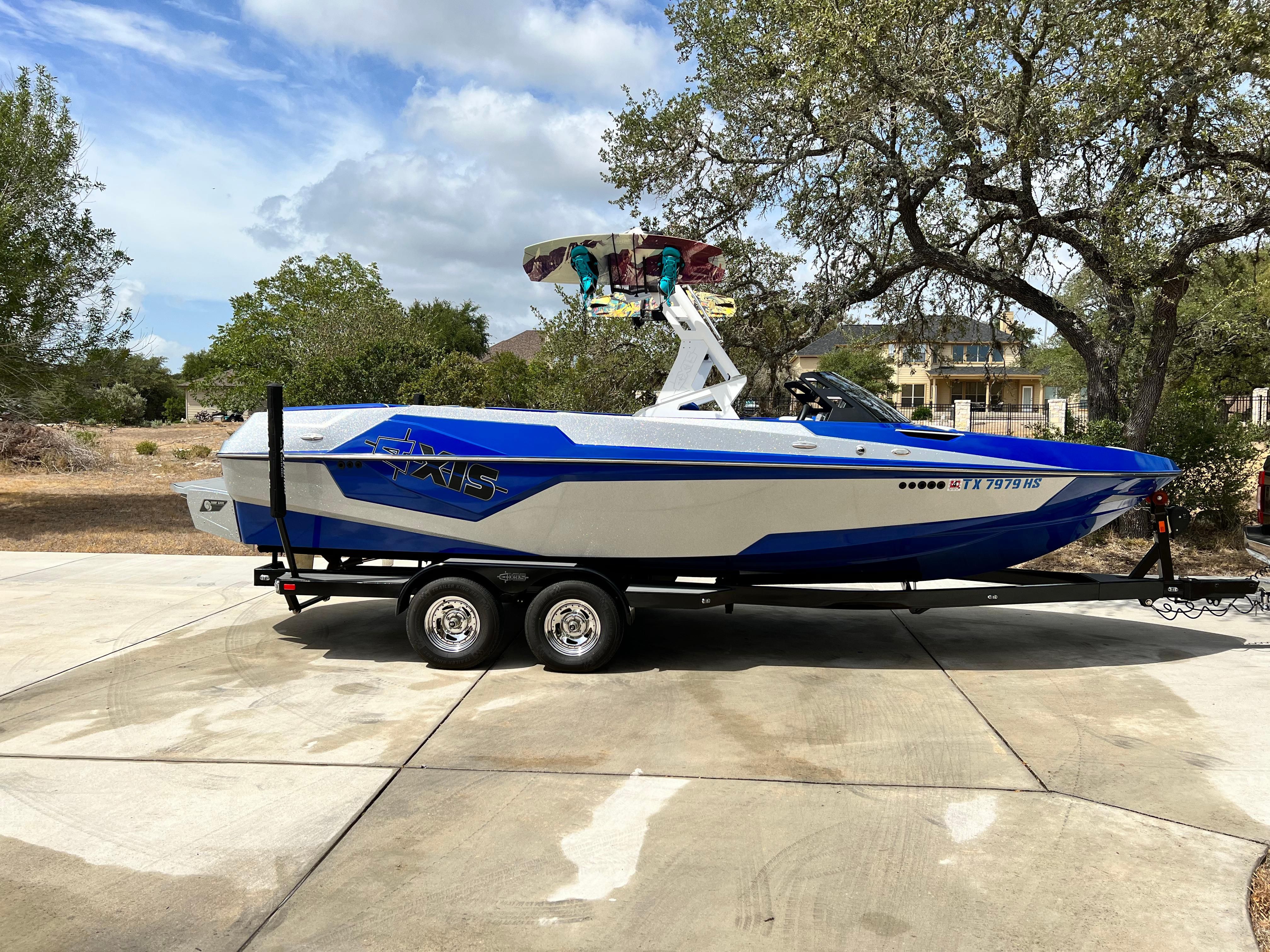Axis T23 2019 Axis T23 boat on trailer, blue and white design, parked outdoors.
