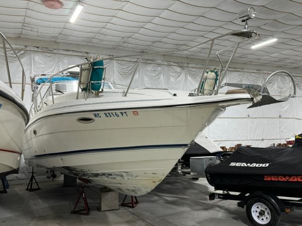 Rinker 280 Fiesta Vee 1993 Rinker 280 Fiesta Vee boat stored indoors, alongside a covered Sea-Doo.