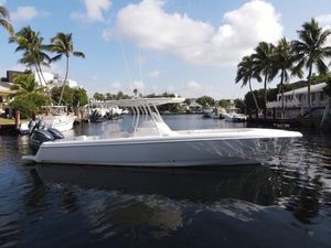 Intrepid 327 Center Console 2014 Intrepid 327 Center Console boat on a sunny waterfront with palm trees.