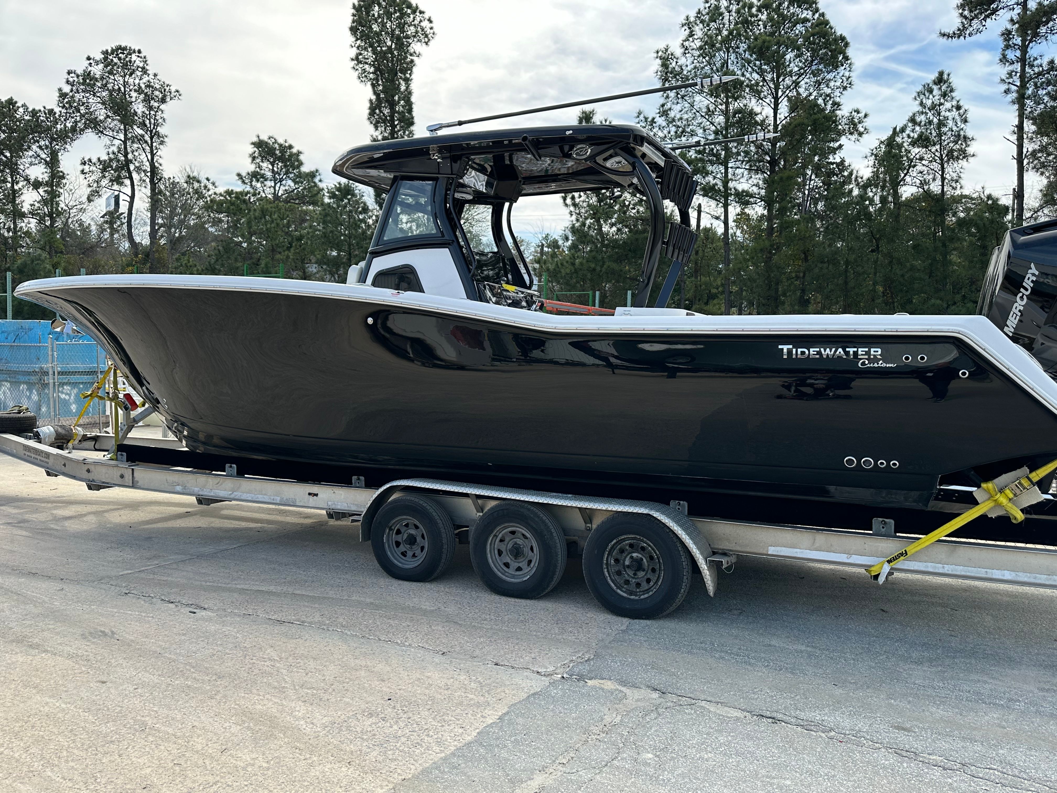 Tidewater 320 CC ADVENTURE CUSTOM 2024 Tidewater 320 CC Adventure Custom boat on trailer, black hull, outdoor setting.