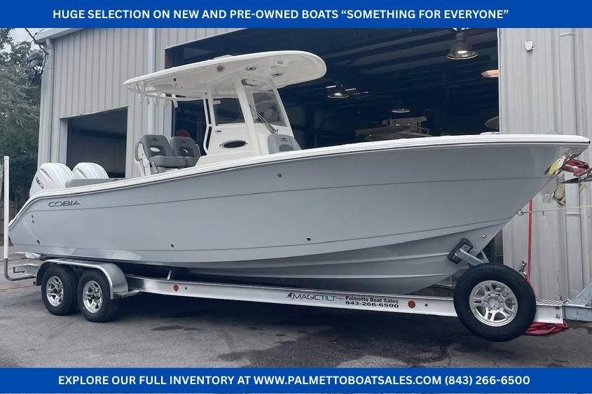 Cobia 262 Center Console 2024 Cobia 262 Center Console boat on trailer outside a warehouse.