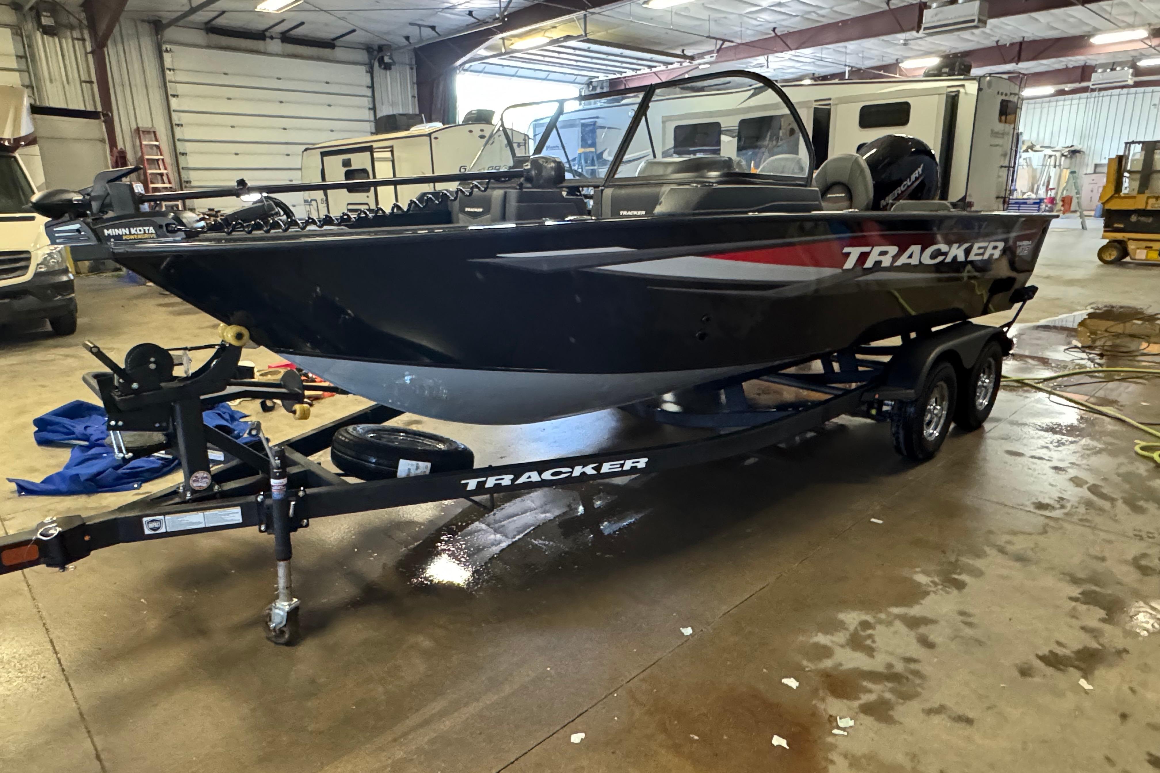 Tracker Targa V-18 Combo 2026 Tracker Targa V-18 Combo boat on trailer in a garage setting.