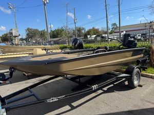 Excel Eclipse 2025 Excel Eclipse boat on trailer, parked outdoors under clear blue sky.