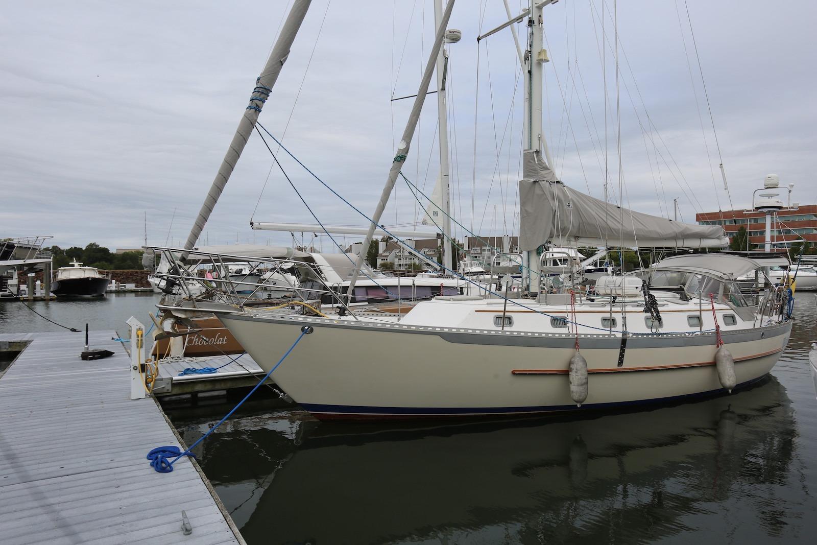 Pacific Seacraft 40 2004 Pacific Seacraft 40 sailboat docked at marina, overcast sky, calm water.