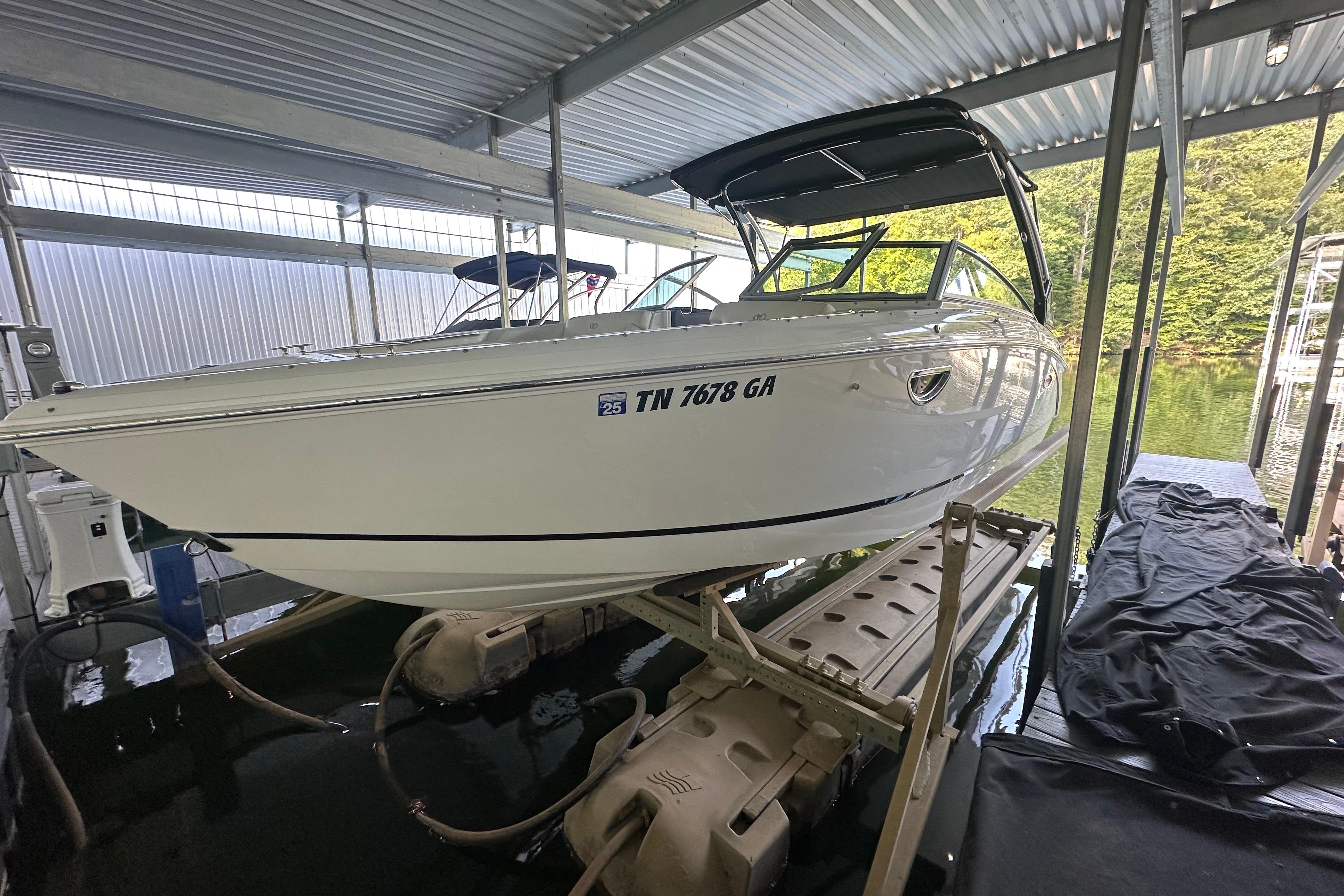 Cobalt R5 2018 Cobalt R5 boat docked in a covered marina, side view.