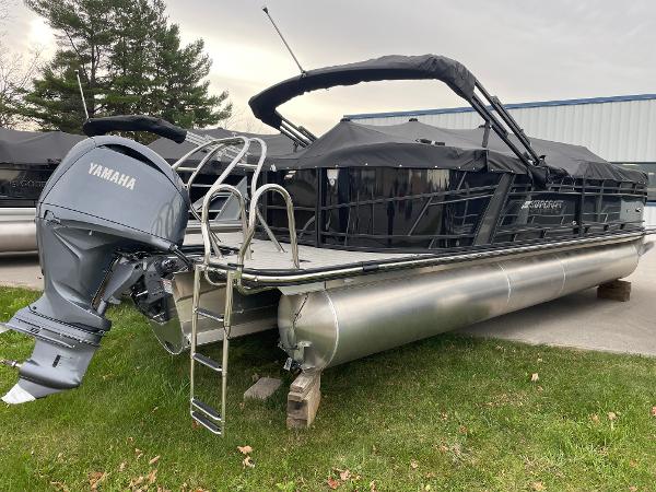 Starcraft SLS 5 2024 Starcraft SLS 5 pontoon boat with Yamaha outboard motor, parked on grass.
