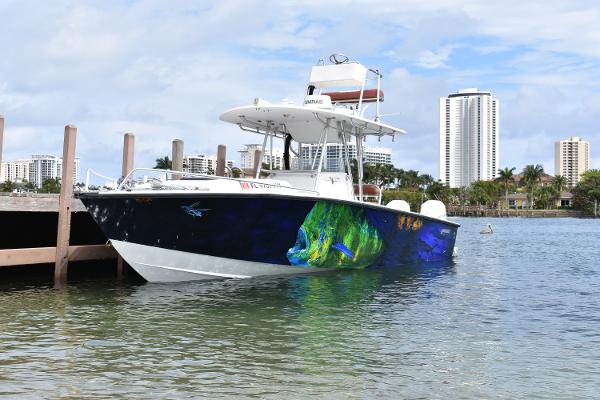 Jupiter 31 Cuddy Cabin 1993 Jupiter 31 Cuddy Cabin boat docked with colorful marine artwork.