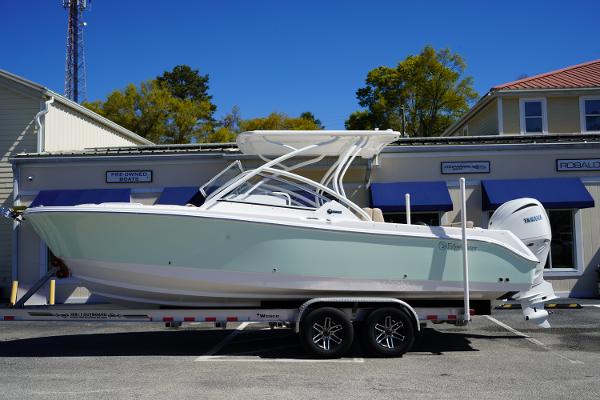Edgewater 248 CX 2025 Edgewater 248 CX boat on trailer, parked outside a building under clear blue sky.