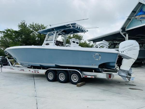 Fountain 38cc 2020 Fountain 38cc boat on a triple-axle trailer, parked outdoors.