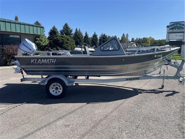 Klamath 18 Open windshield 2023 Klamath 18 Open Windshield boat on trailer in outdoor setting.