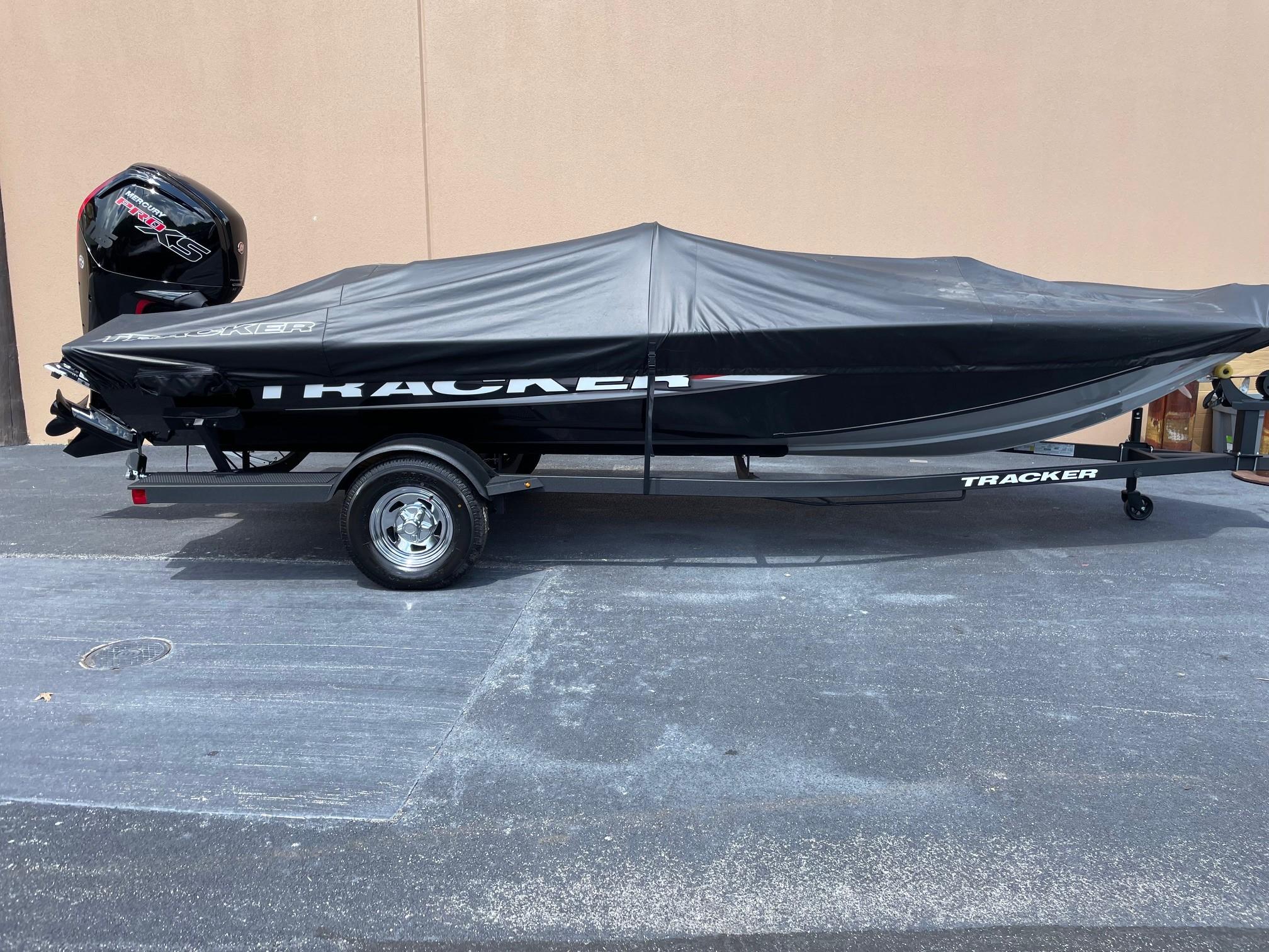Tracker Pro Team 190 2025 Tracker Pro Team 190 boat with cover on trailer, parked outdoors.