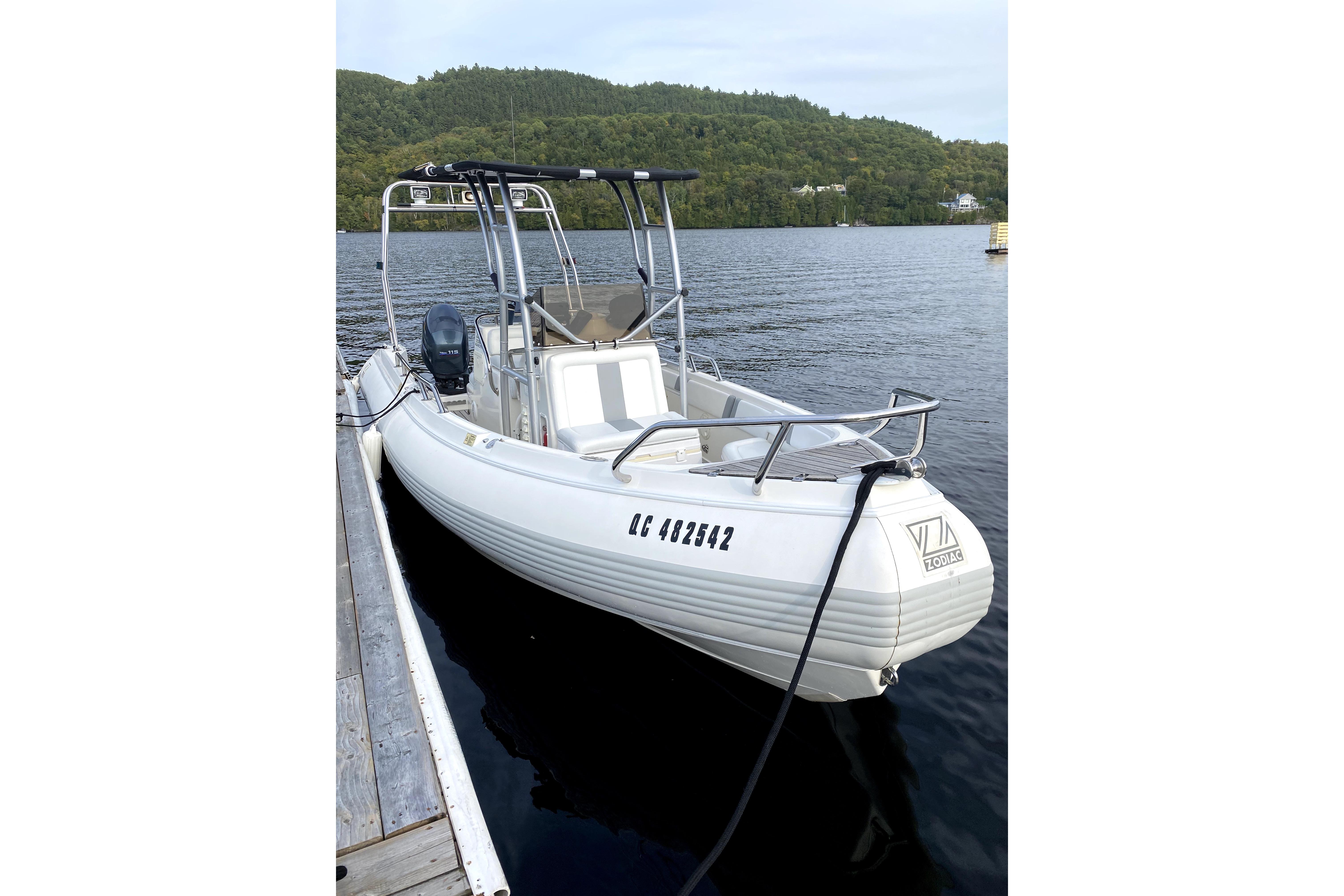 Zodiac Hurricane Eclipse 22 2001 Zociac Hurricane Eclipse 22 boat docked on a serene lake.