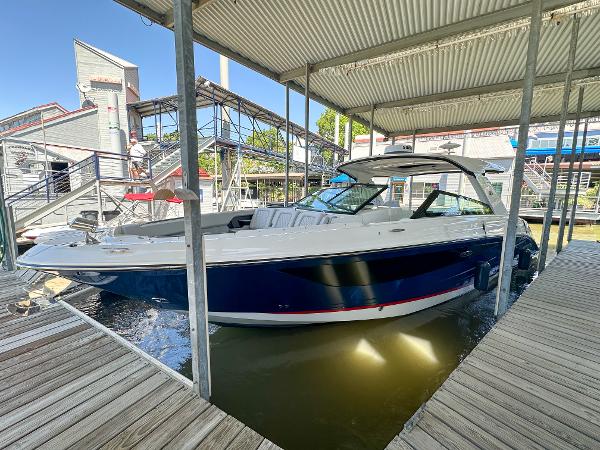 Sea Ray SLX 400 Outboard 2023 Sea Ray SLX 400 Outboard boat docked under a covered marina.