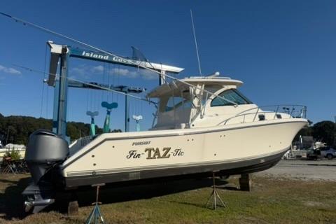 Pursuit OS 375 Offshore 2010 Pursuit OS 375 Offshore boat on land, under clear blue sky.
