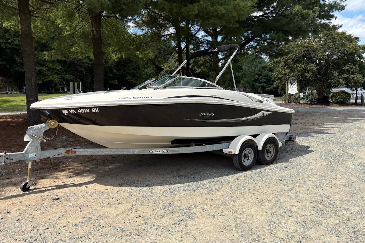 Sea Ray 195 Sport 2008 Sea Ray 195 Sport boat on trailer, parked outdoors under trees.