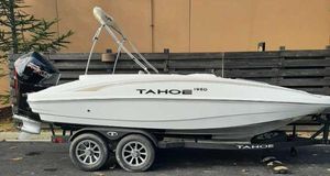 Tahoe 1950 2025 Tahoe 1950 boat on trailer, parked outdoors.