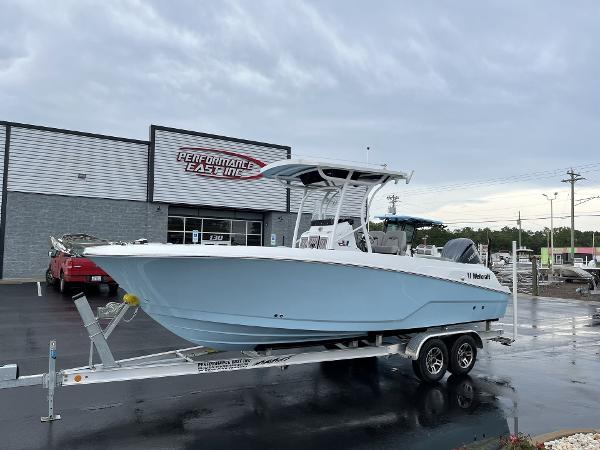 Wellcraft 242 Fisherman 2023 Wellcraft 242 Fisherman boat on a trailer outside Performance East Inc. dealership.