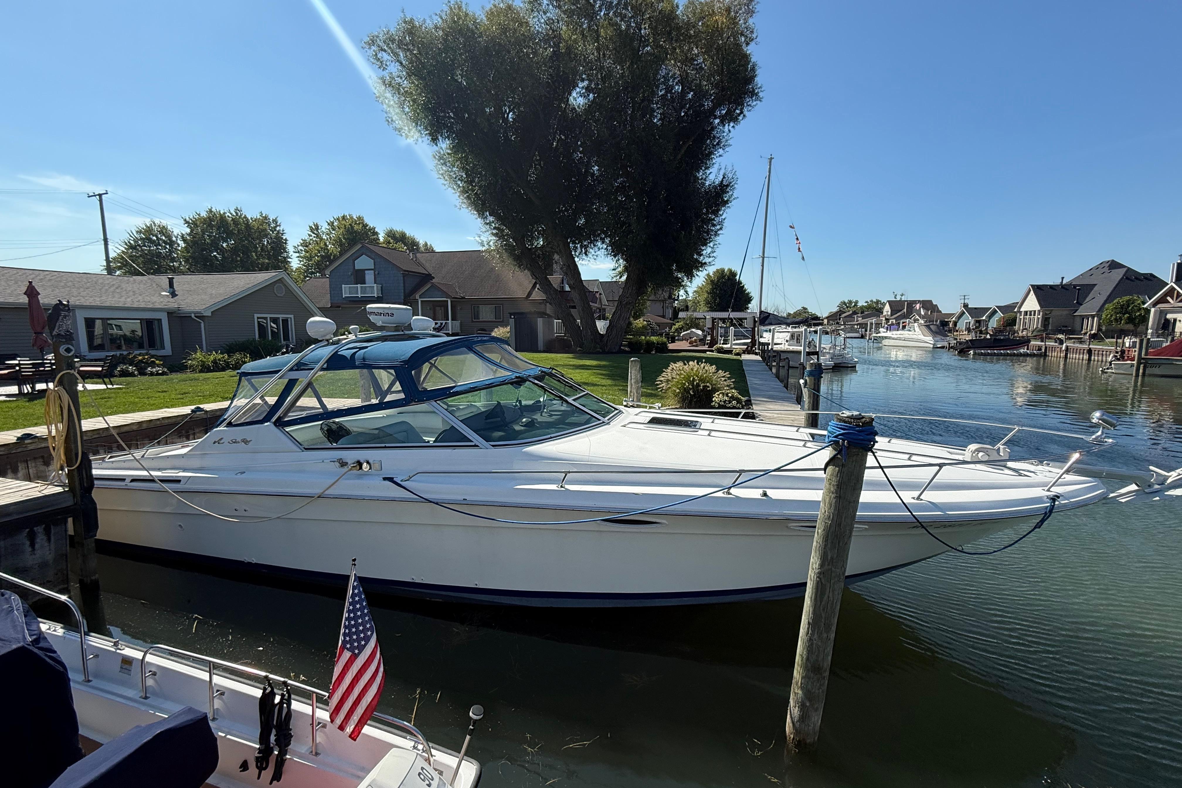 Sea Ray 380 Sun Sport 1990 Sea Ray 380 Sun Sport docked in a scenic residential canal.