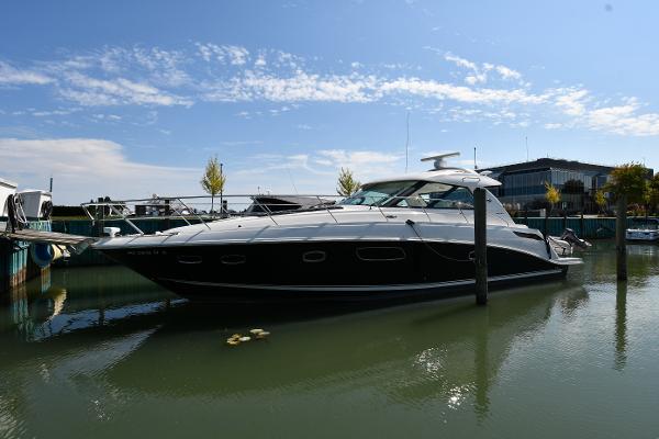 Sea Ray 450 Sundancer 2010 Sea Ray 450 Sundancer yacht docked in a marina under a clear blue sky.
