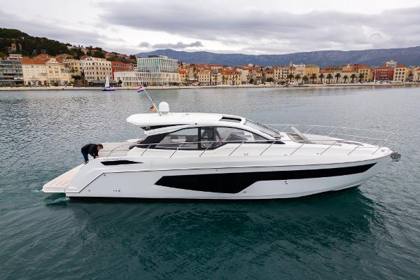 Azimut Atlantis 51 2019 Azimut Atlantis 51 yacht cruising near a coastal cityscape.