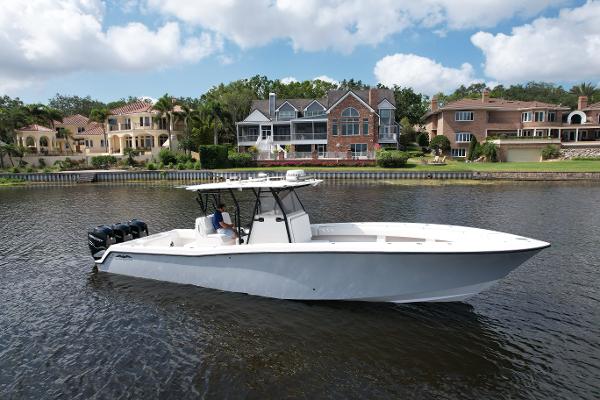 Invincible 36 Open Fisherman 2009 Invincible 36 Open Fisherman boat on water, luxury homes in background, clear sky.