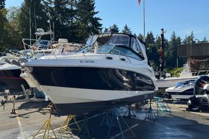 Chaparral 290 Signature 2011 Chaparral 290 Signature boat on stands in a marina, surrounded by trees and other boats.