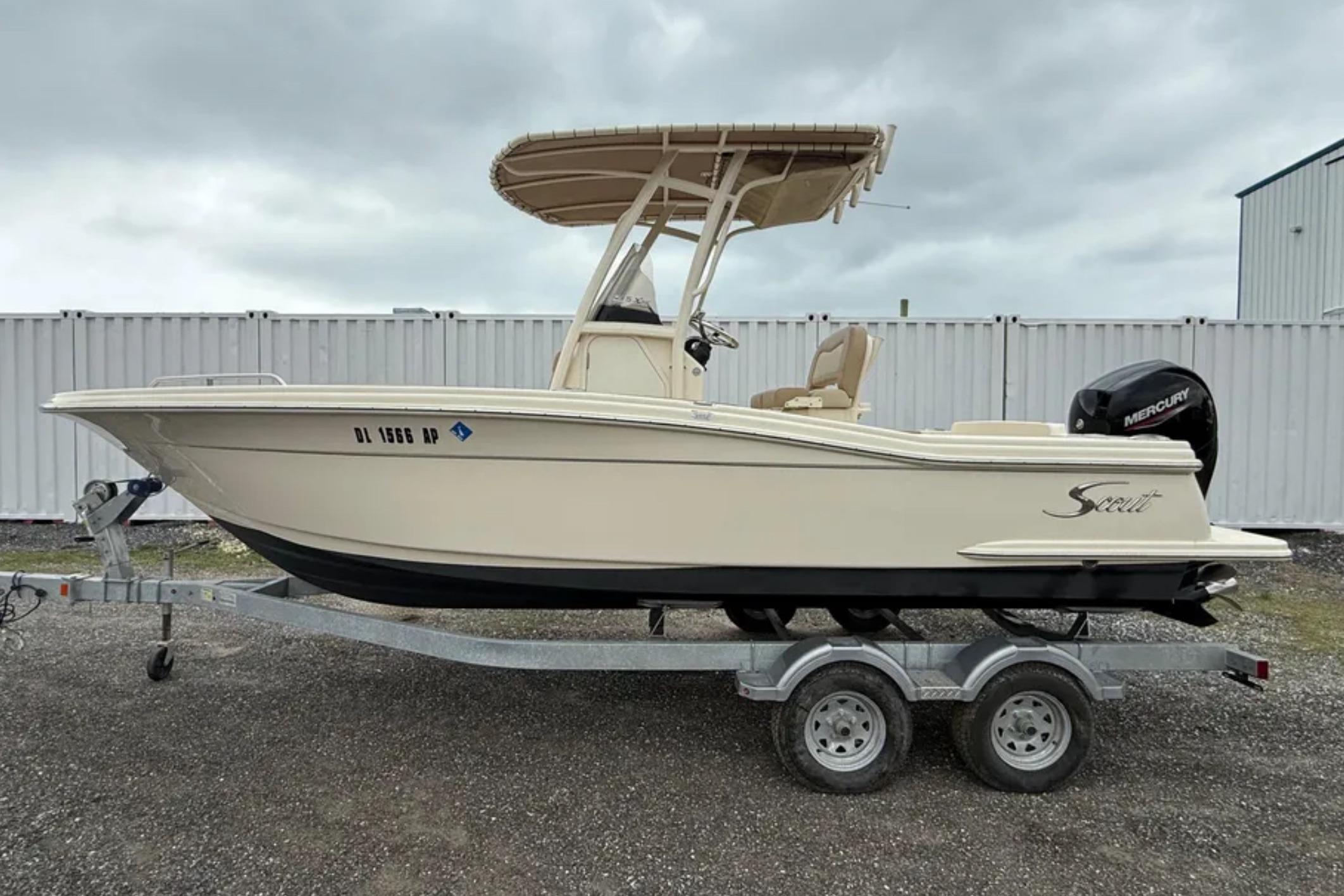 Scout 215 XSF 2023 Scout 215 XSF boat on trailer, side view, overcast sky.