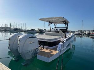 STERK 31 RC 2025 STERK 31 RC boat docked in marina with twin outboard engines.