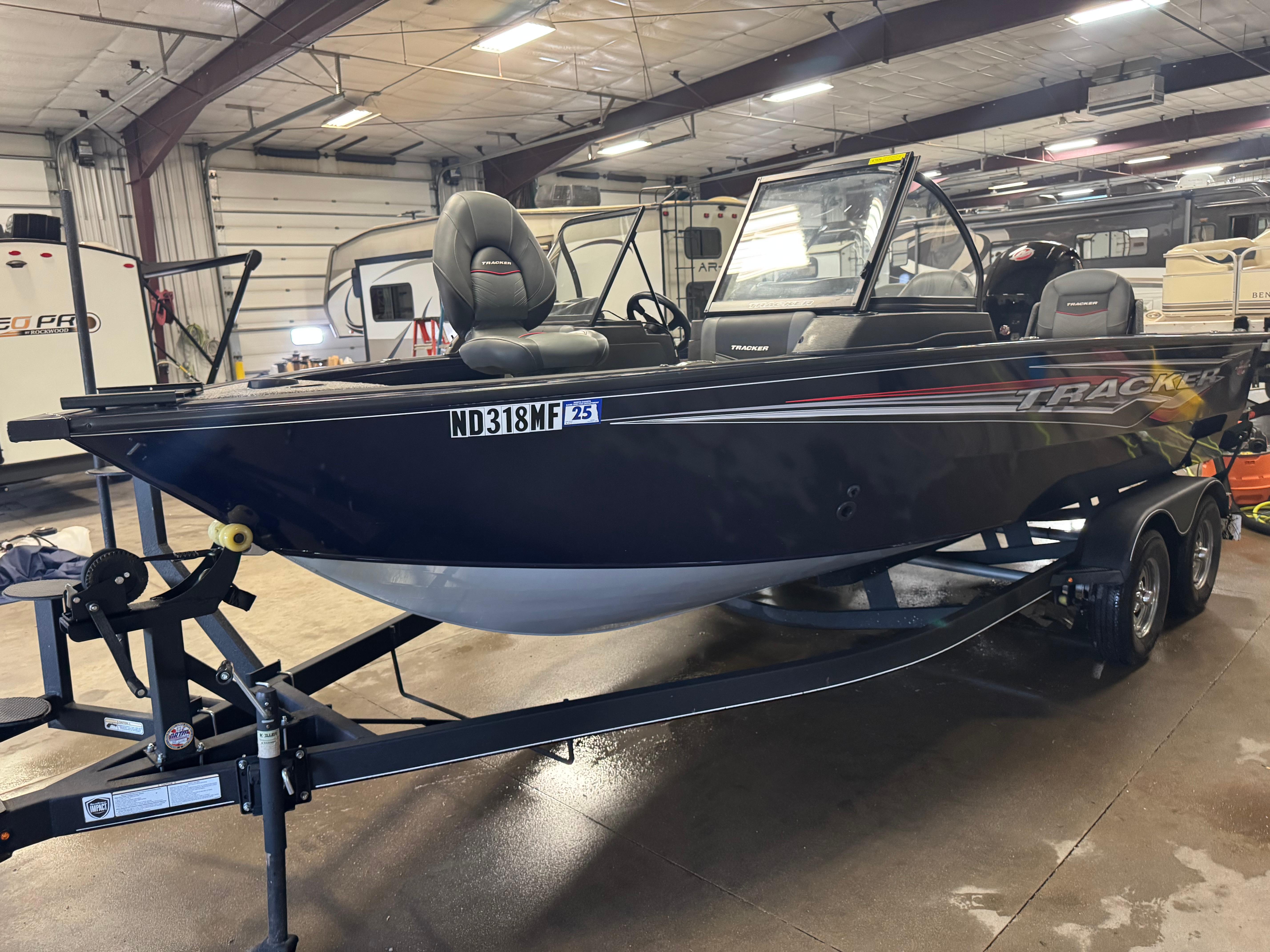 Tracker Targa V-18 WT 2023 Tracker Targa V-18 WT boat on trailer in indoor storage facility.