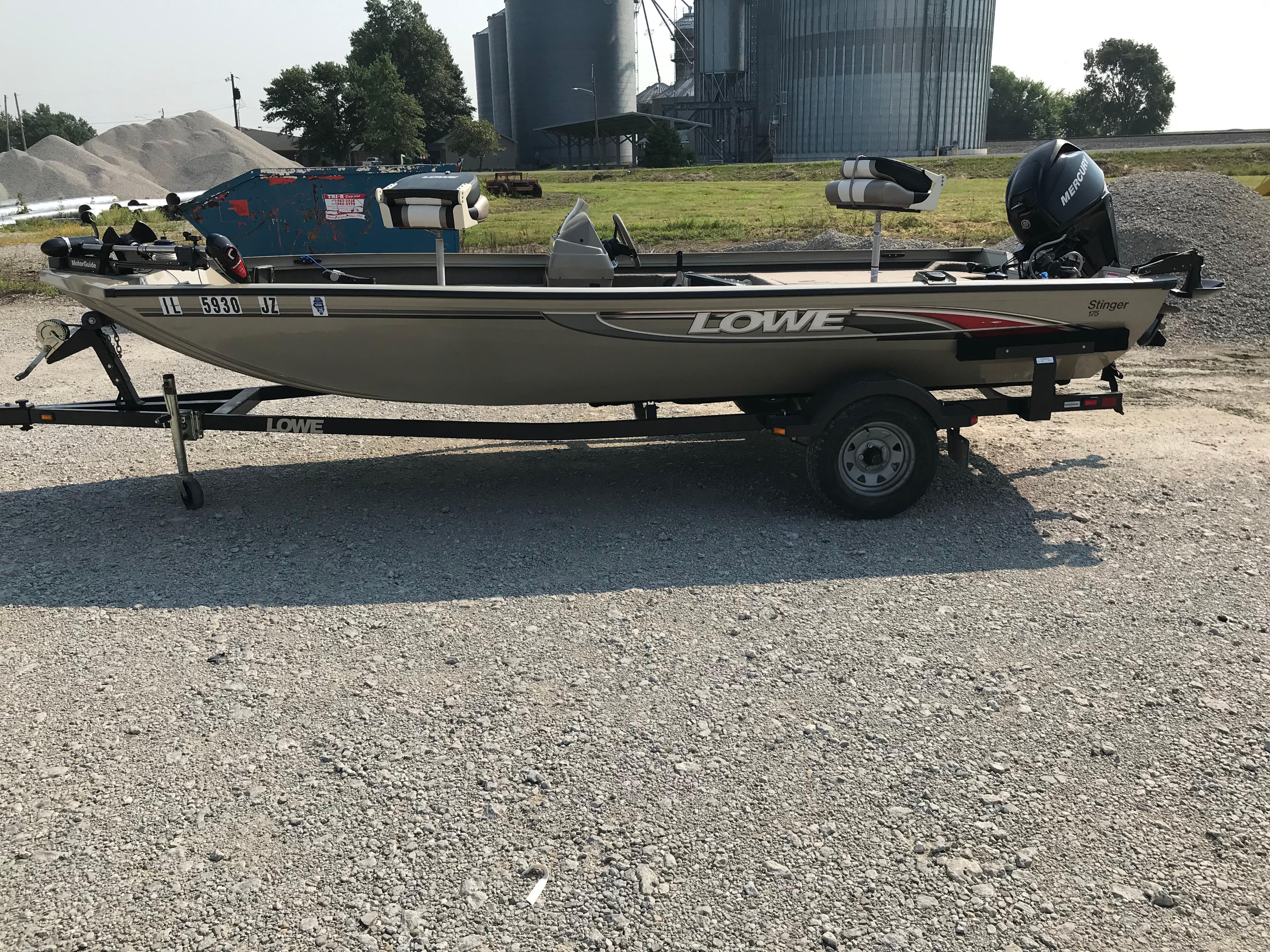 Lowe Stinger 175 2006 Lowe Stinger 175 boat on trailer, parked on gravel, with industrial background.