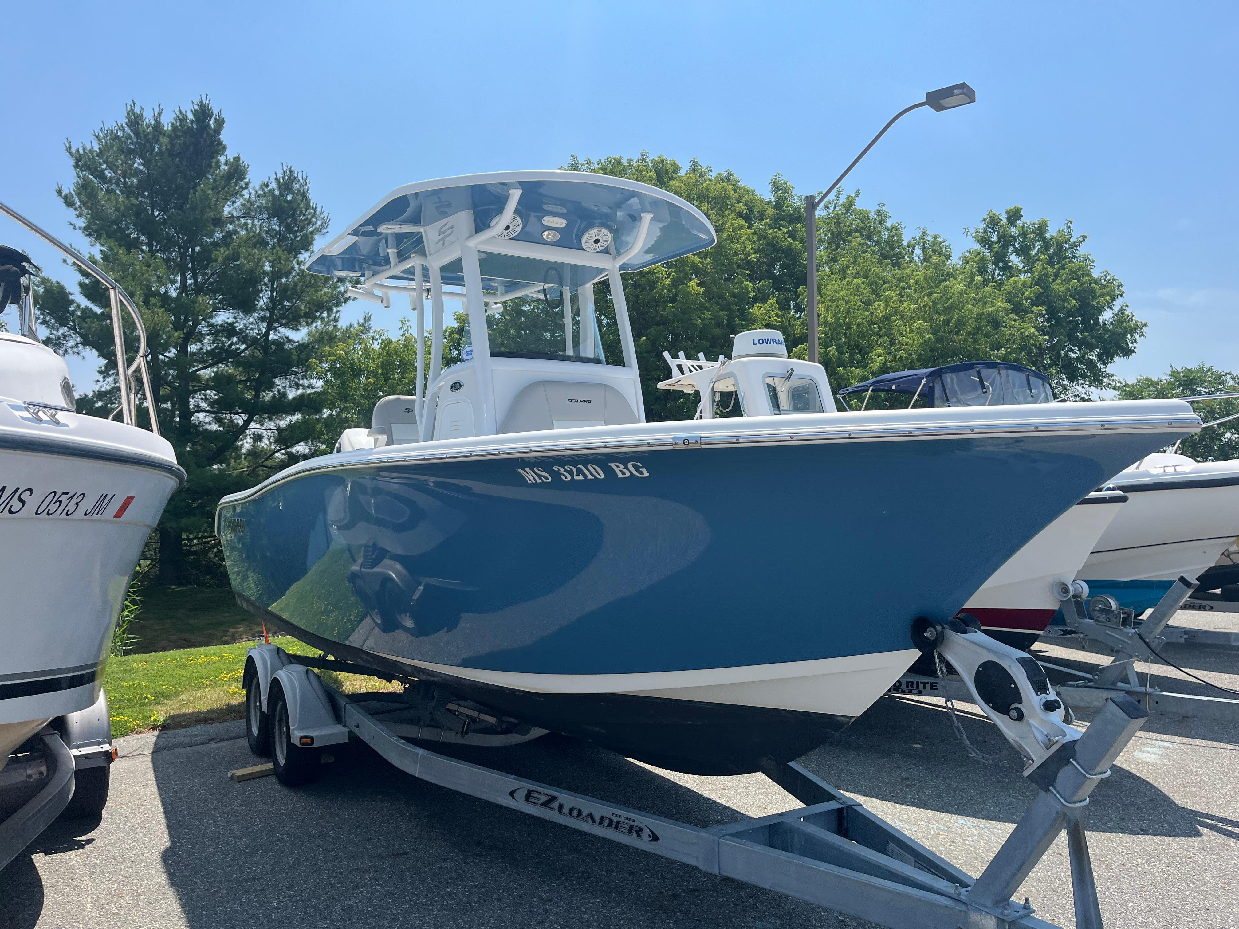Sea Pro 239 Center Console 2019 Sea Pro 239 Center Console boat on trailer, parked outdoors.
