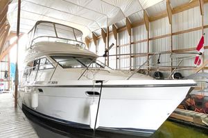 Bayliner 3788 Command Bridge Motoryacht 2002 Bayliner 3788 Convertible Sedan docked in a covered marina.