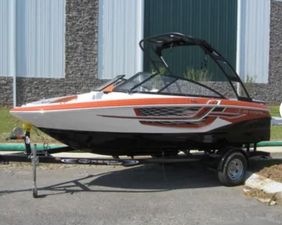 Regal 1900 ESX Bowrider 2018 Regal 1900 ESX Bowrider boat on trailer, parked outdoors.