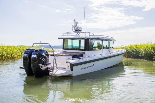 Axopar 37 Aft Cabin 2018 Axopar 37 Aft Cabin boat with twin outboard engines on calm water.