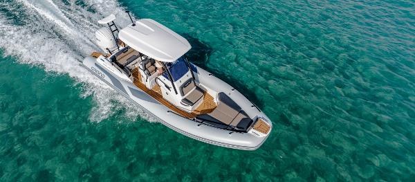 Grand Inflatables G750 2025 Grand Inflatables G750 boat cruising on clear turquoise water.