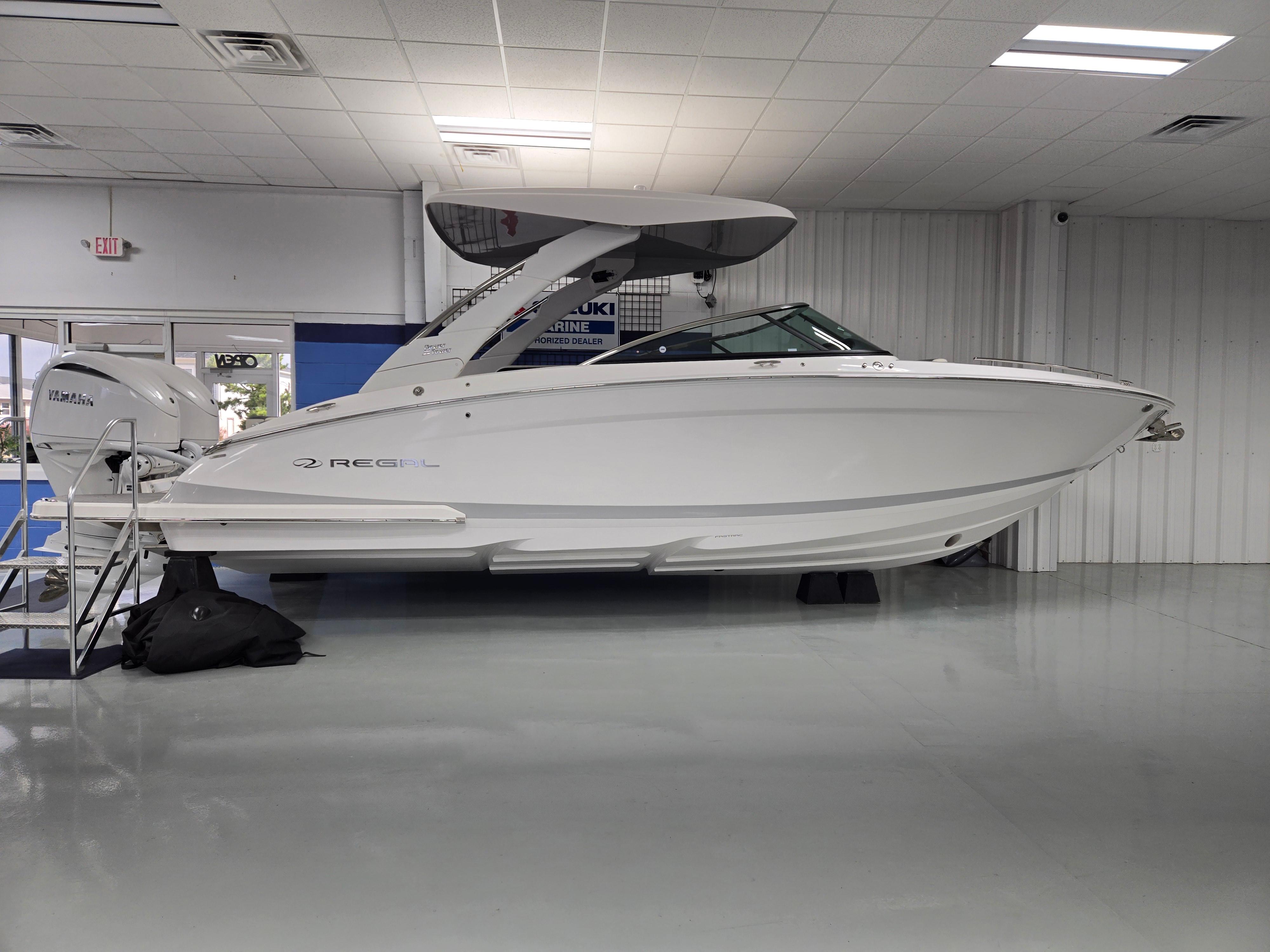Regal LX9 2025 Regal LX9 boat displayed indoors, side view, white hull, modern design.