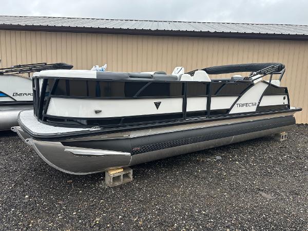 Trifecta 23 RFESS 2025 Trifecta 23 RFESS pontoon boat, sleek design, parked on gravel.