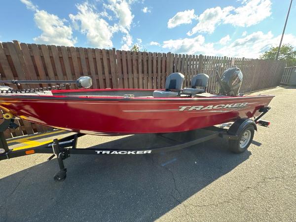 Tracker Super Guide V-16 T Red 2025 Tracker Super Guide V-16 T boat on trailer, parked outdoors.