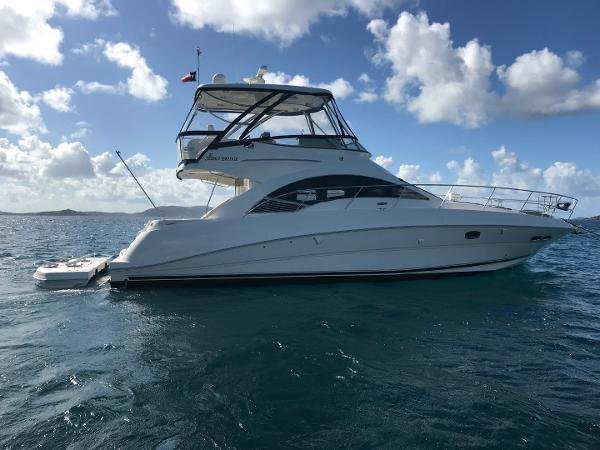 Sea Ray 47 Sedan Bridge 2008 Sea Ray 47 Sedan Bridge yacht on open water under a partly cloudy sky.