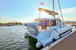 Bali 4.1 2019 Bali 4.1 catamaran docked at marina, sunny day, French flag flying.