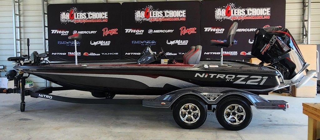 Nitro Z21 XL Pro 2026 Nitro Z21 XL Pro boat in showroom with promotional banners in background.