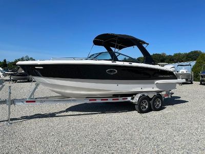 Chaparral 270 OSX 2025 Chaparral 270 OSX boat on trailer, black and white design, parked outdoors.