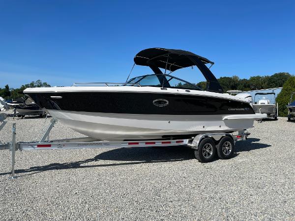 Chaparral 270 OSX 2025 Chaparral 270 OSX boat on trailer, black and white design, parked outdoors.