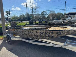 Excel 1860 F4 Shallow Water 2025 Excel 1860 F4 Shallow Water boat with camouflage design on a trailer.