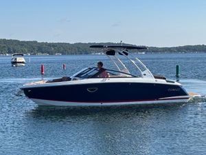 Cobalt R6 2025 Cobalt R6 boat cruising on a serene lake with scenic background.